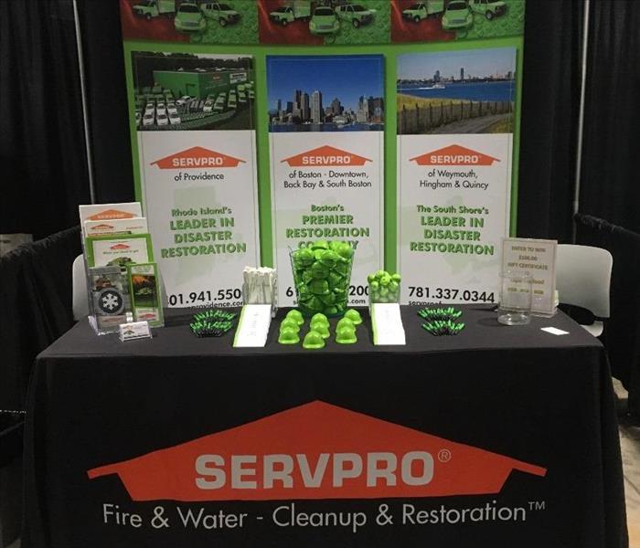 a booth with a black tablecloth and SERVPRO logo