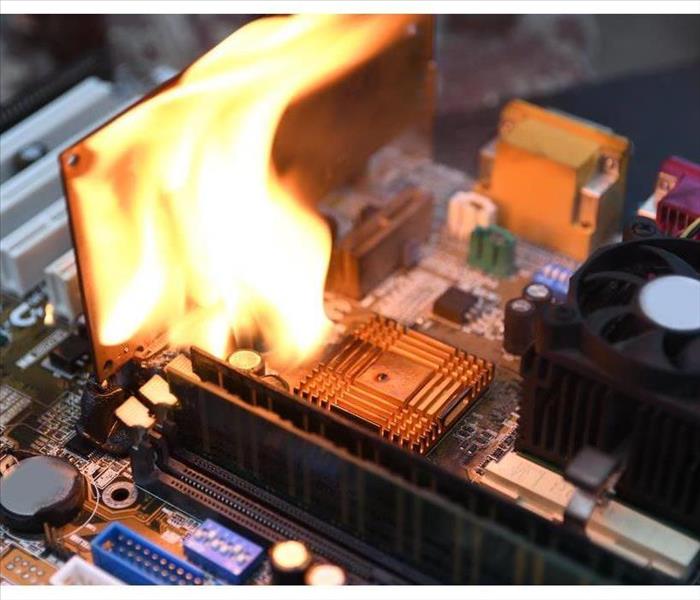 Fire Burning, blazing computer motherboard, cpu, gpu video card, processor on circuit board with electronic