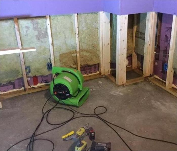 Air mover placed on a basement. Concept basement restoration